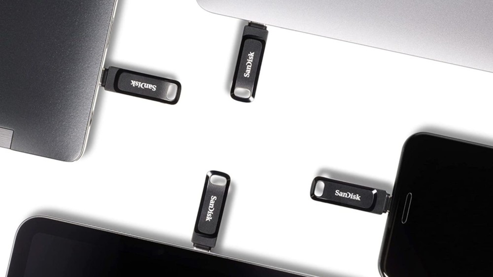 Black flash drives sticking out of four different electronic devices