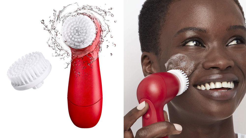 A bristled cleansing brush is used to clean a woman's face.