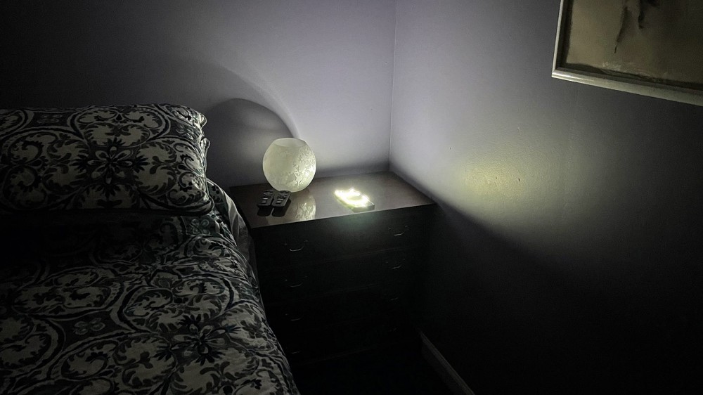 A phone brightly lighting an otherwise dark room