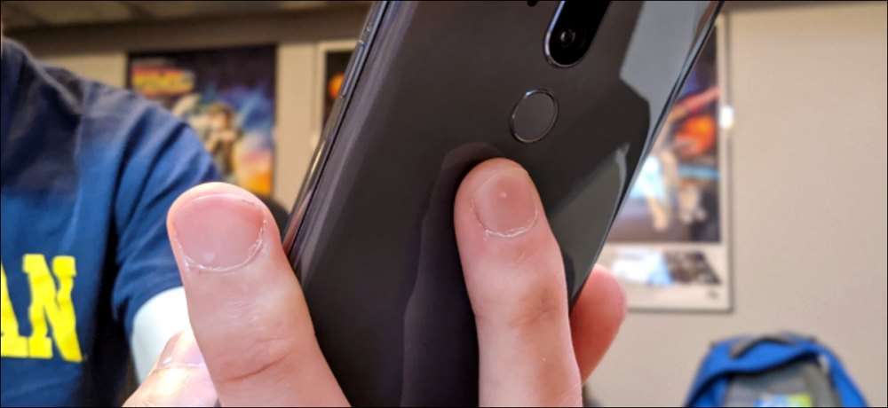 Someone's fingers on the back of an android phone.