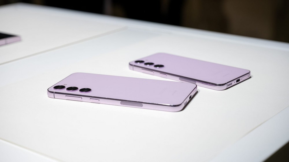 Samsung Galaxy S23 and S23 Plus in Lavender laying next to each other displaying their buttons and USB-C ports