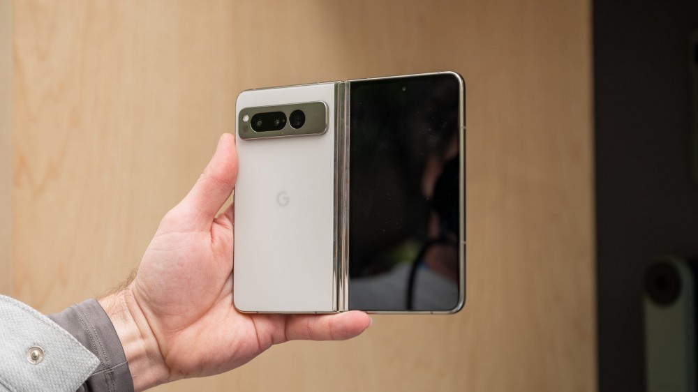 Person holding the Google Pixel Fold with the phone open and the back facing the camera