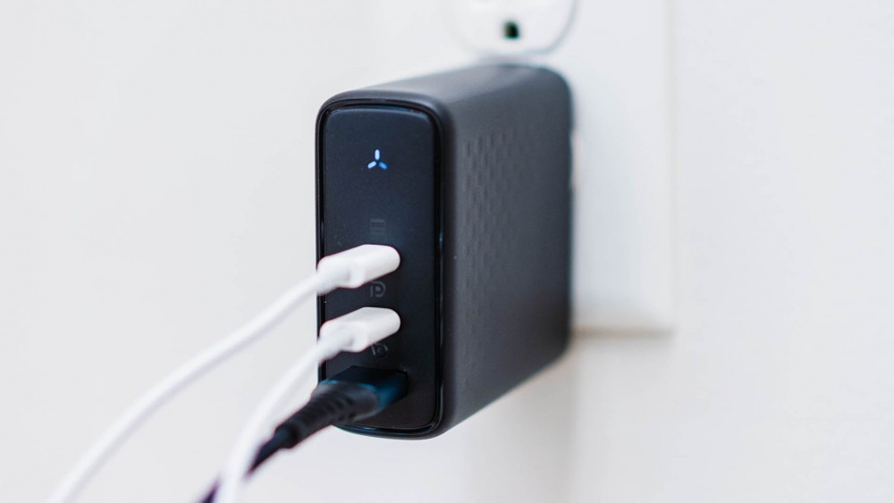 The VOLTME Revo 140W 3 Ports PD3-1 GaN charger plugged into a wall with cables inserted